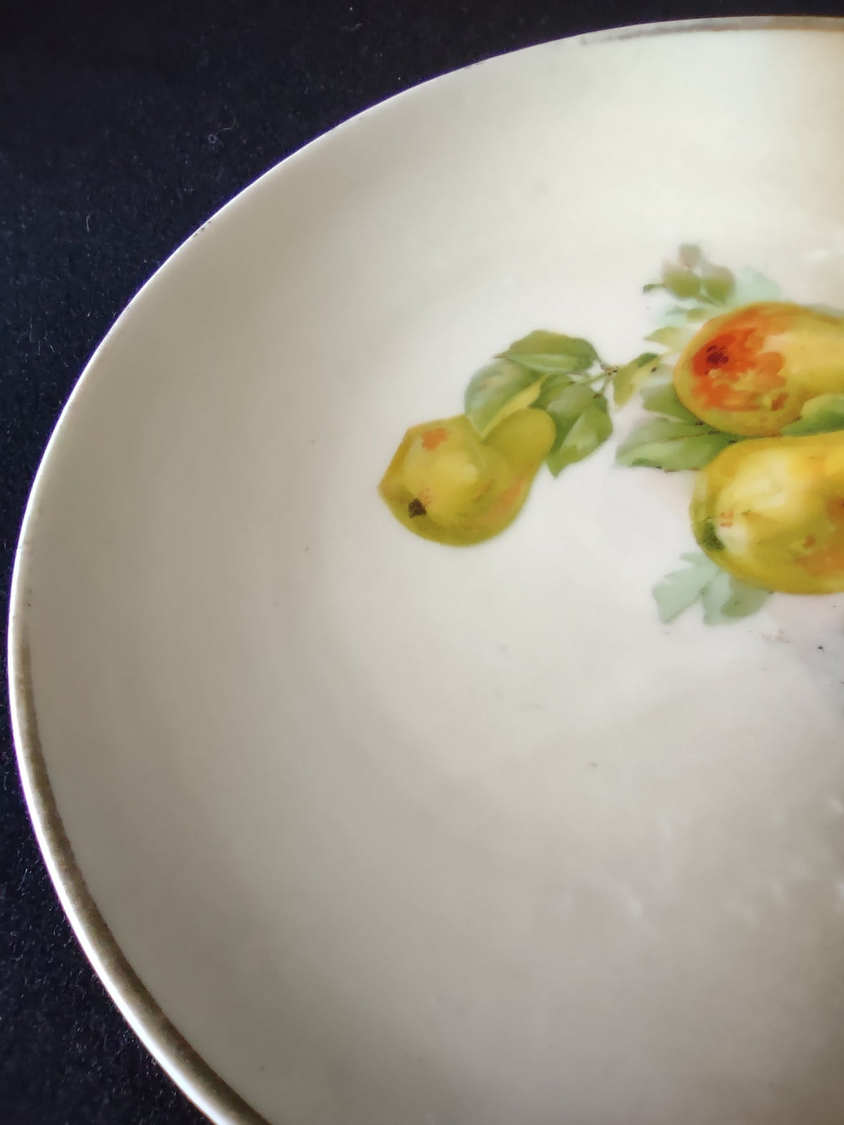 Hand-painted pears plate second base close-up showing plain white porcelain underside no backstamp or country of origin mark
