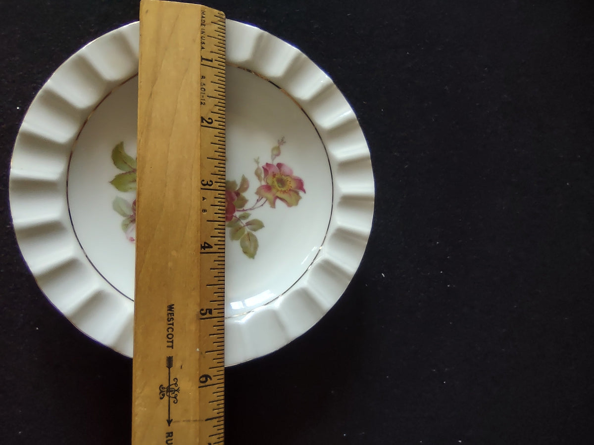 Schumann Arzberg Wild Rose plate angled lower view showing gold wear and losses on scalloped rim tips consistent with age and overall plate form