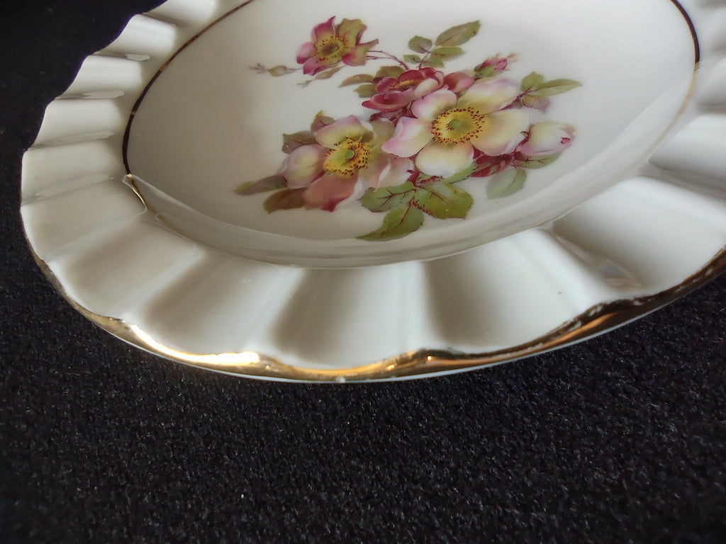 Schumann Arzberg Wild Rose plate angled view showing scalloped reticulated rim profile with raised vertical ribs and gold scallop tip details