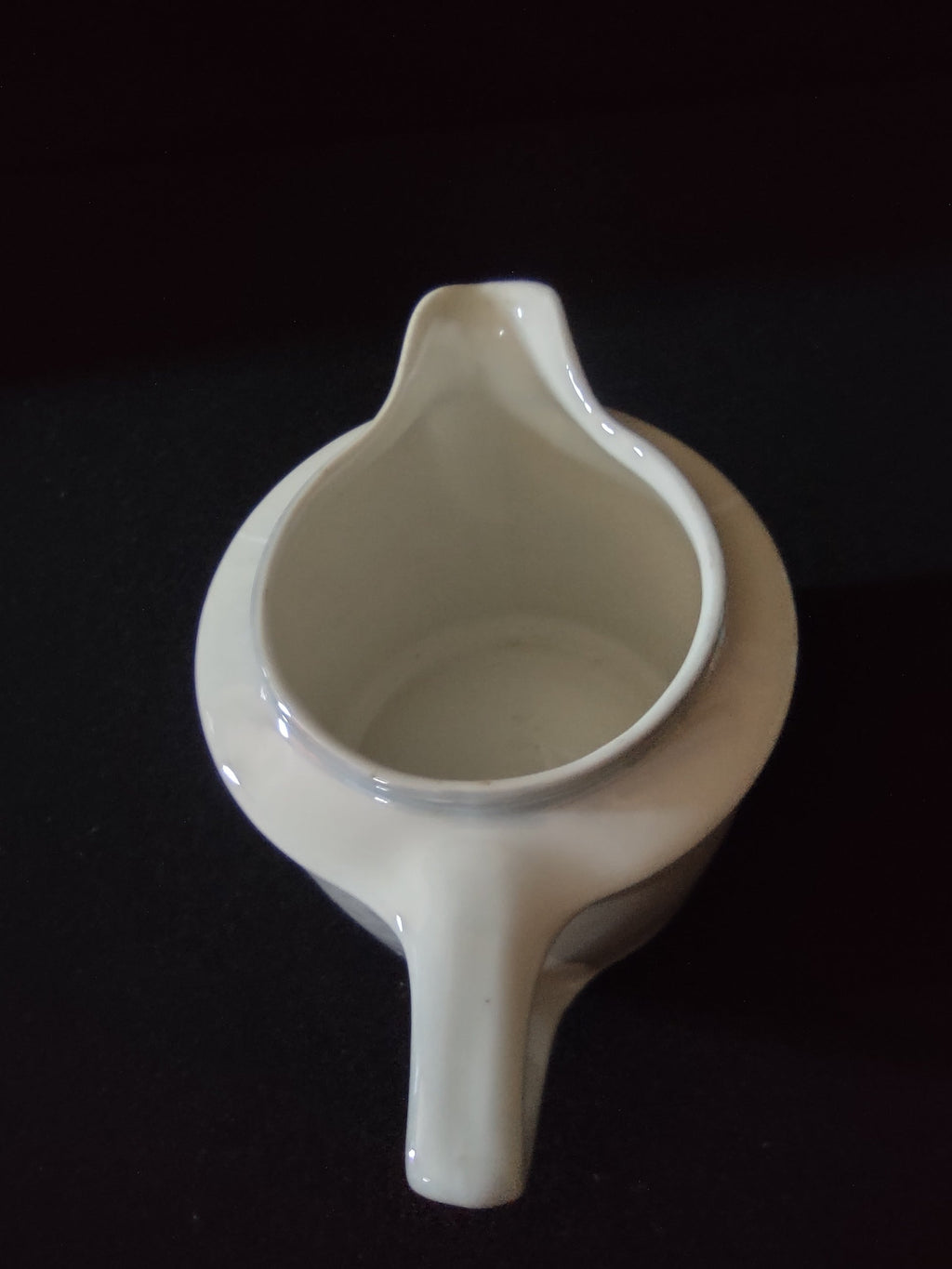 Pink roses porcelain creamer opposite side showing single cream rose with pink center and muted green foliage on off-white ground with loop handle visible