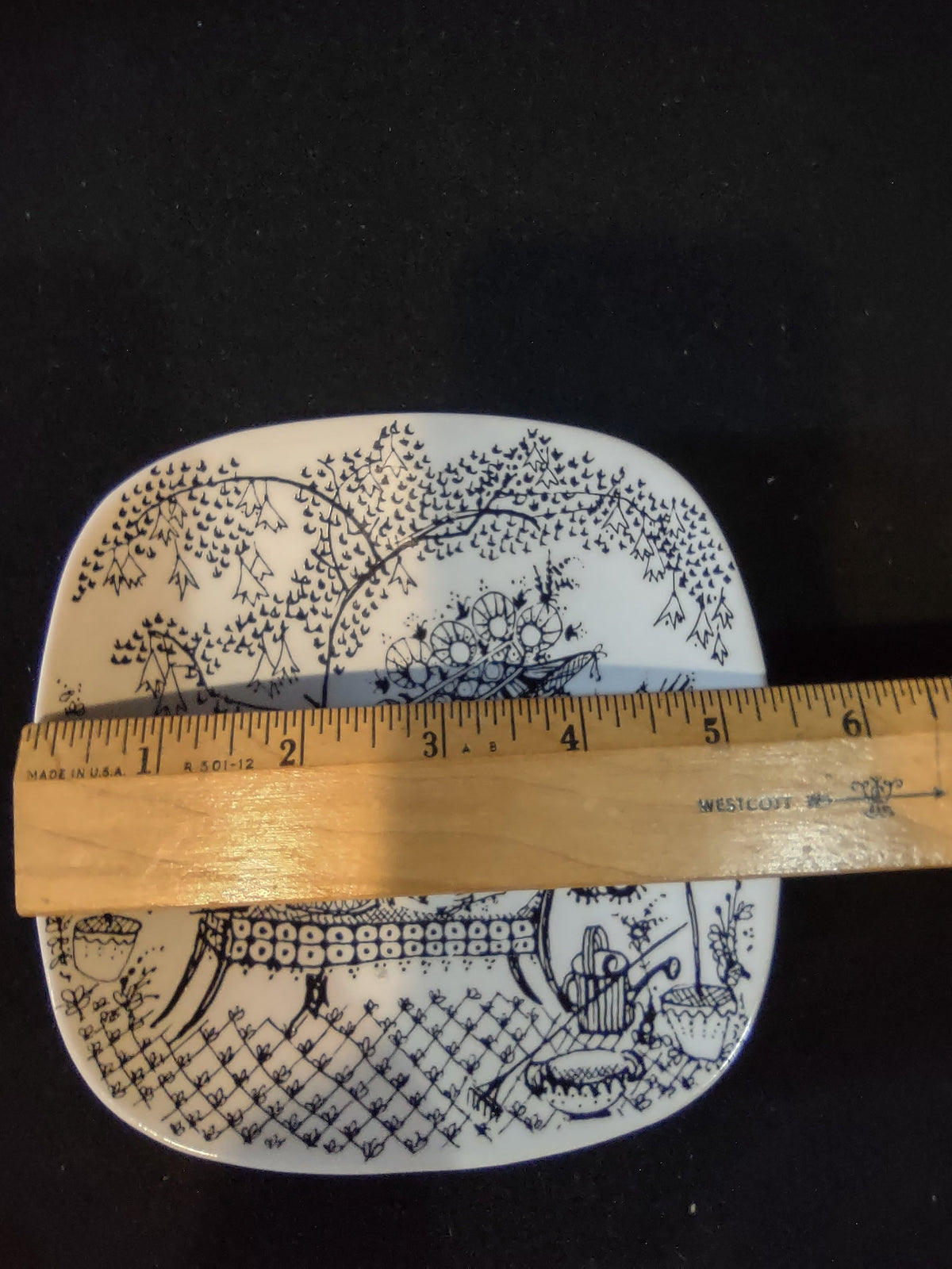 Rosenthal Wiinblad Fiesta square plate with ruler showing approximately 6 inch width across black background