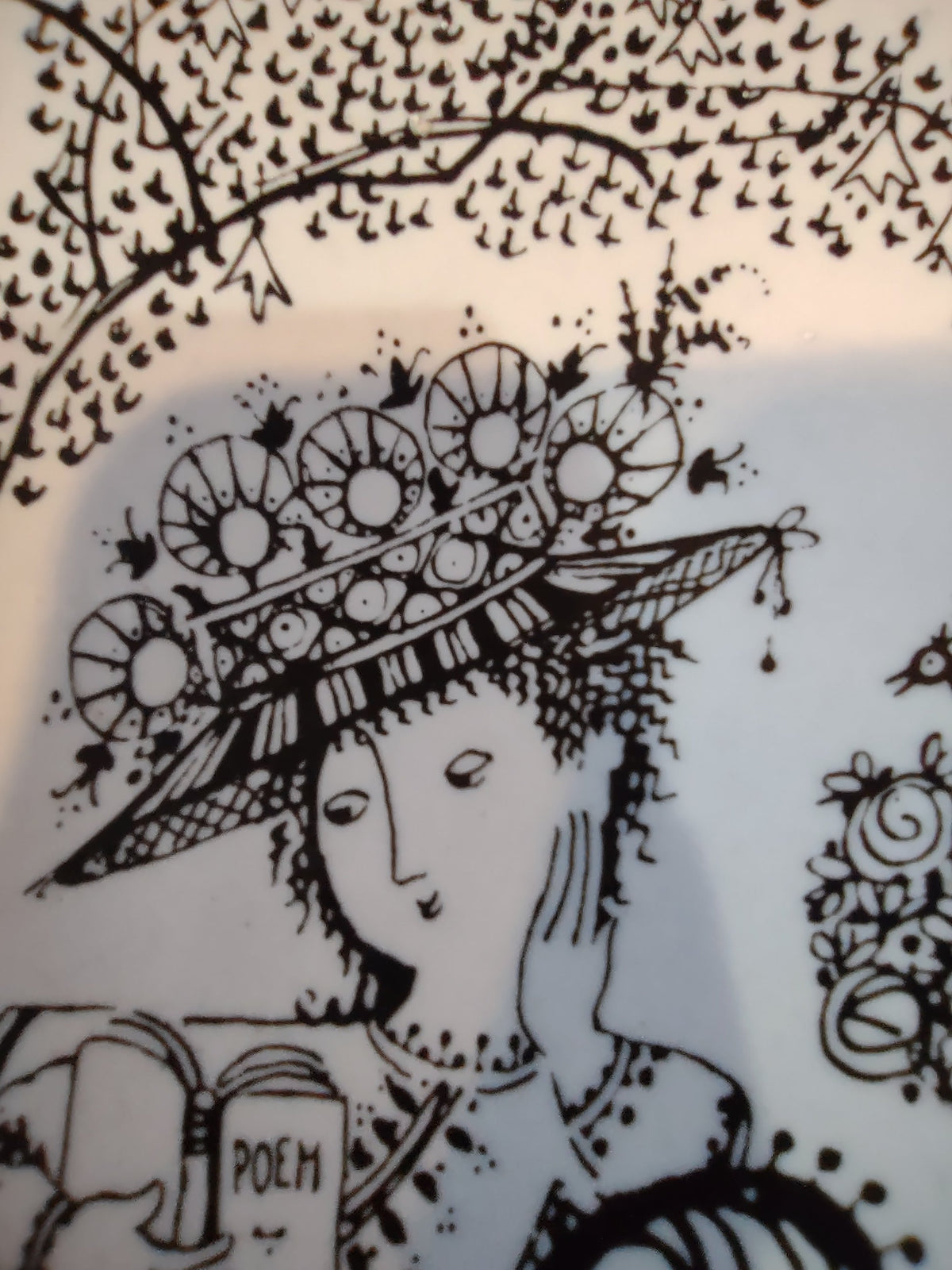 Rosenthal Wiinblad Fiesta plate close-up of right side showing woman profile rose topiary with birds and swirling chaise arm black line linework detail