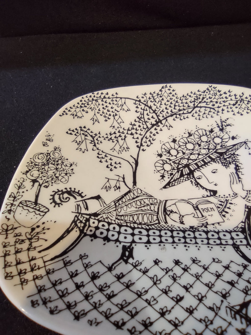 Rosenthal Wiinblad Fiesta plate angled view from lower left showing potted topiary left side watering can lower right and full garden lattice ground detail