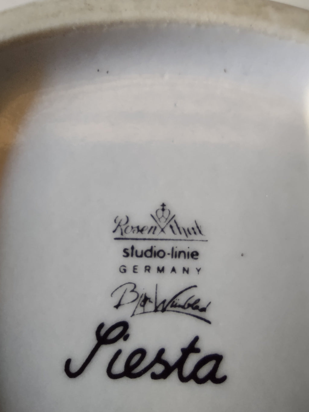 Rosenthal Wiinblad Fiesta plate base close-up showing clean white unglazed foot rim and full backstamp detail on white porcelain ground