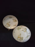 Vintage C Tielsch Altwasser Silesia set of 3 plates overview showing 2 round plates and 1 oval dish with cream rose and gold Art Nouveau border pattern on white ground against black background