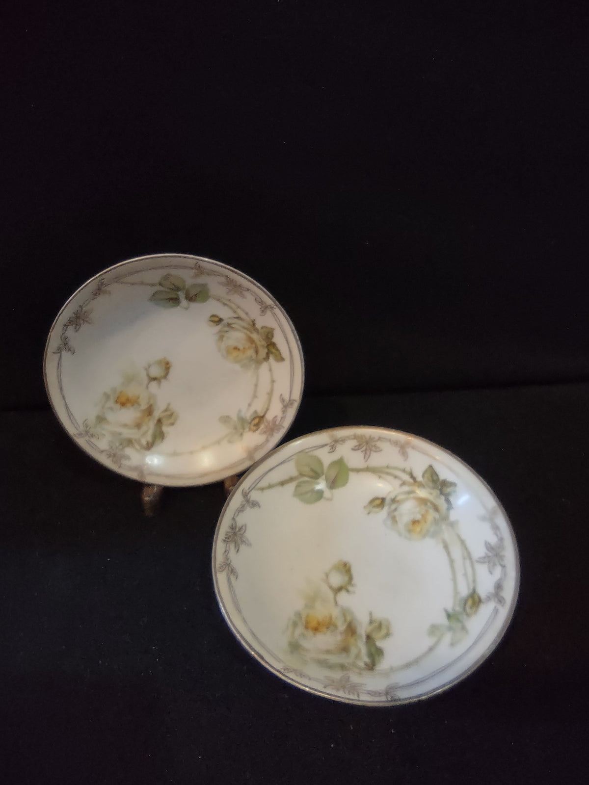 Vintage C Tielsch Altwasser Silesia set of 3 plates overview showing 2 round plates and 1 oval dish with cream rose and gold Art Nouveau border pattern on white ground against black background