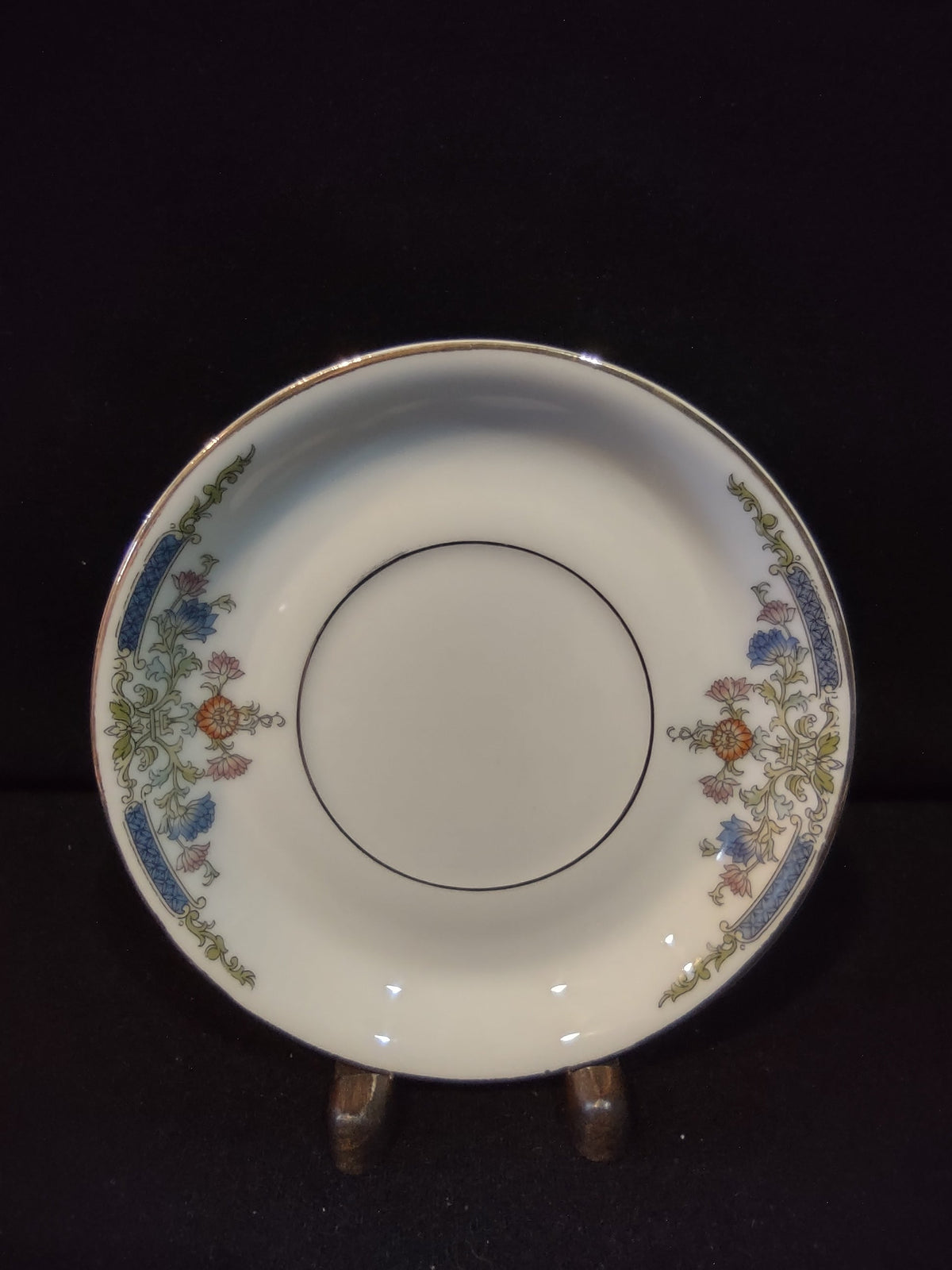 Vintage Hutschenreuther Selb Bavaria saucer top view with ruler showing approximately 5.5 inch diameter blue bellflower orange chrysanthemum gold acanthus border on white ground