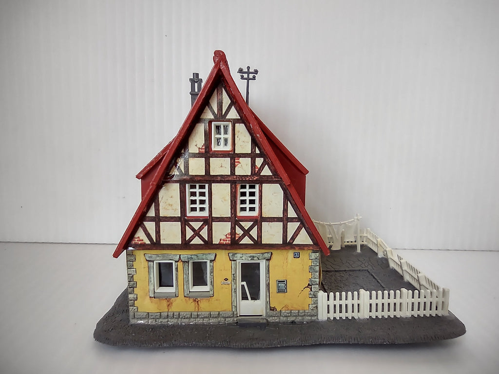 Vintage Vollmer HO scale Fachwerk half-timbered house - front view with white picket fence and courtyard