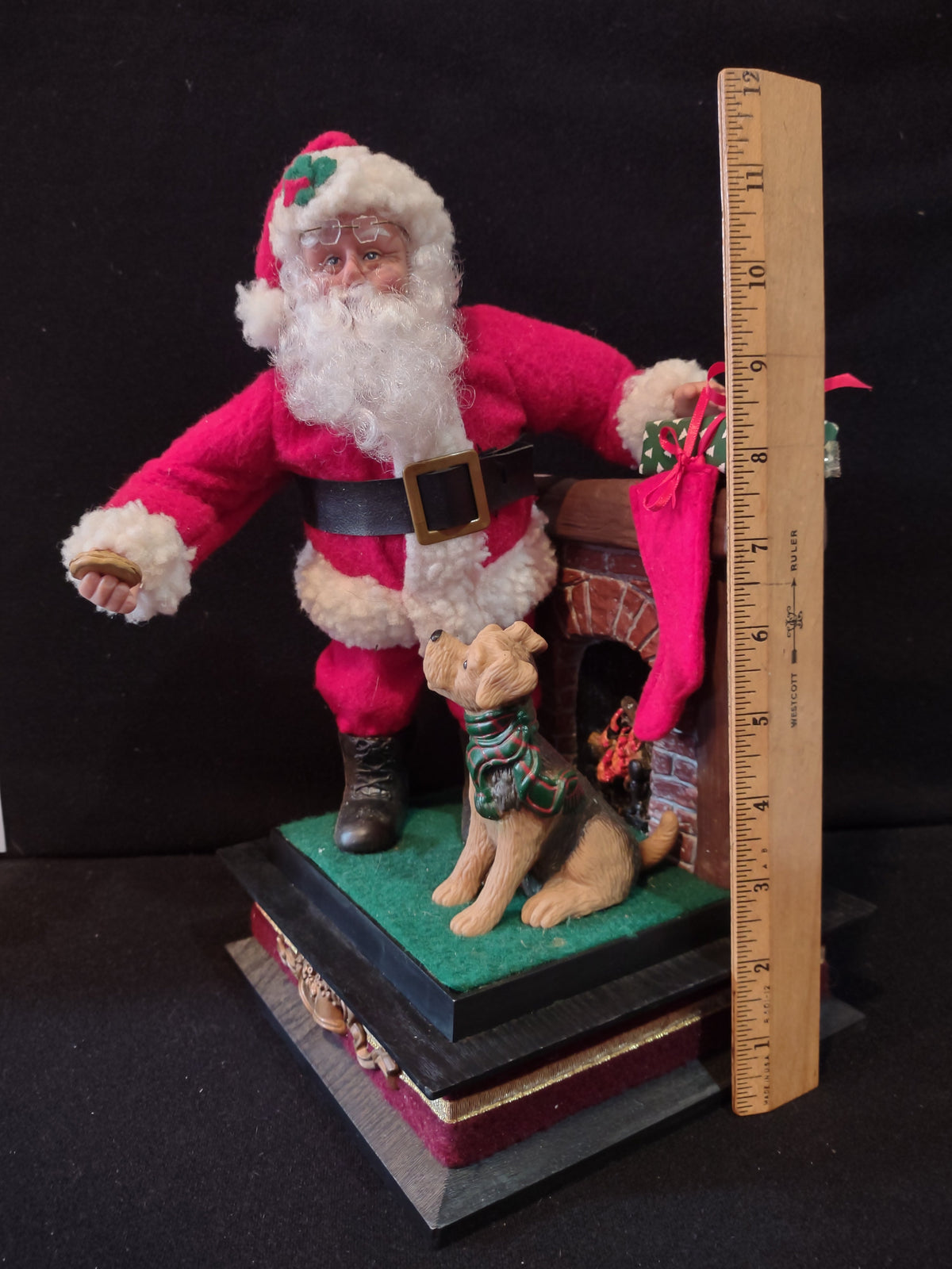 Vintage Holiday Creations Santa with dog and fireplace figurine shown with ruler, approximately 11 inches tall