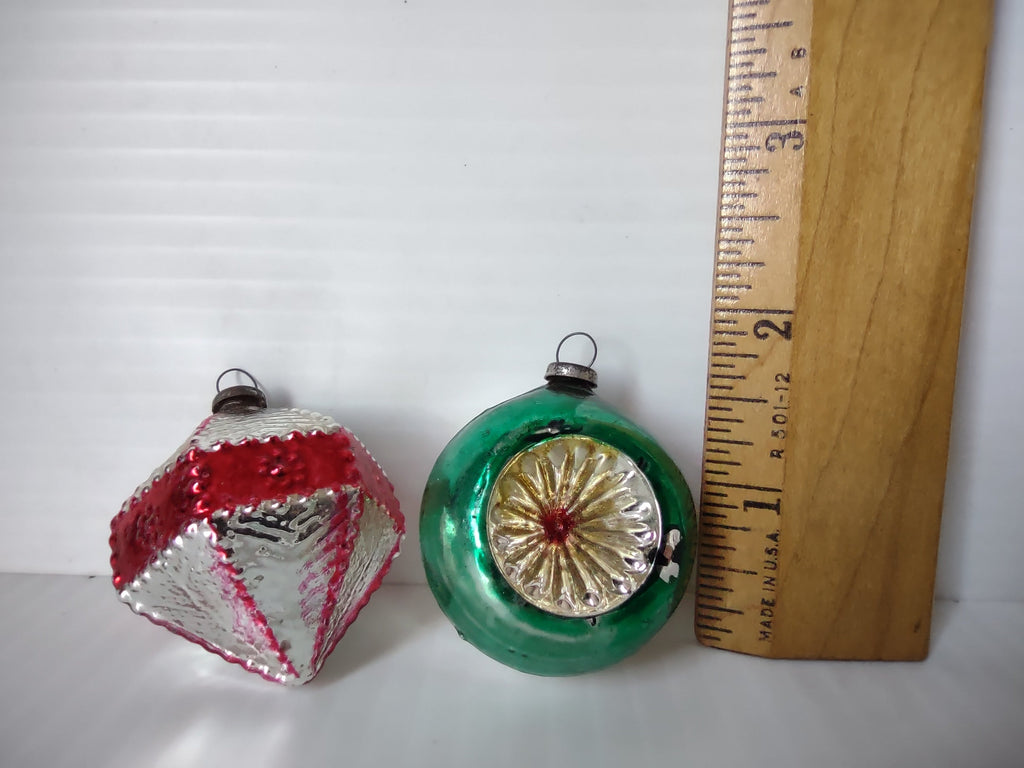 Side view of vintage mercury glass Christmas ornaments showing diamond and ball shapes