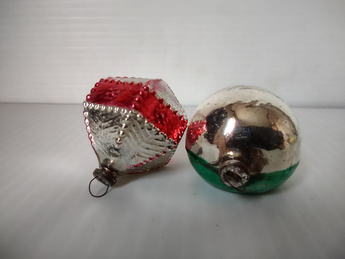Front view of vintage mercury glass reflector ball ornament in green and silver