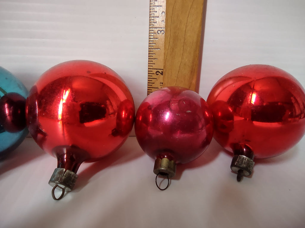 Three ornaments next to ruler showing approximately 1.5 to 2.5 inch diameter sizes