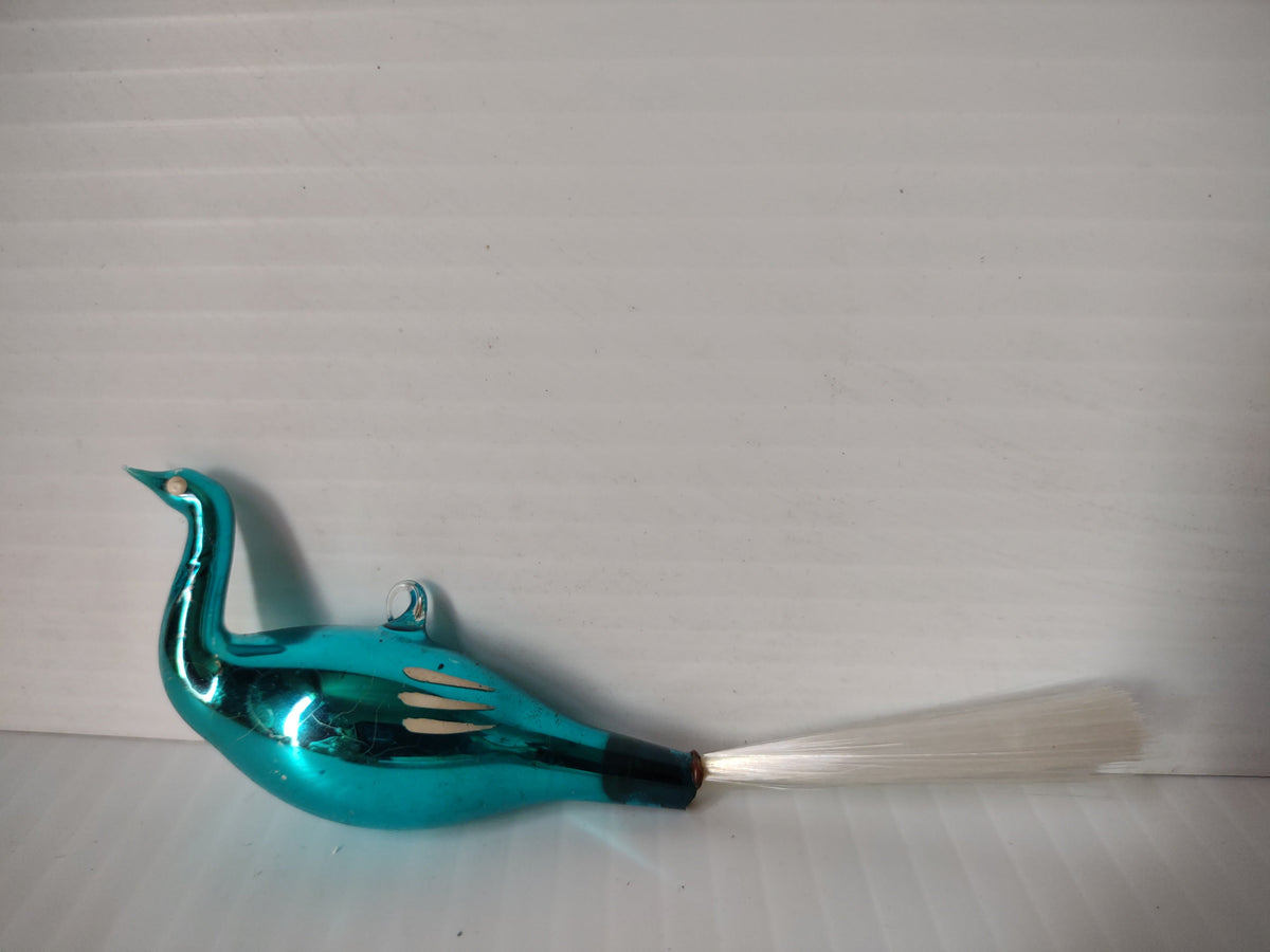 Side view of vintage teal glass bird swan ornament with long white spun glass fiber tail and wire loop hanger