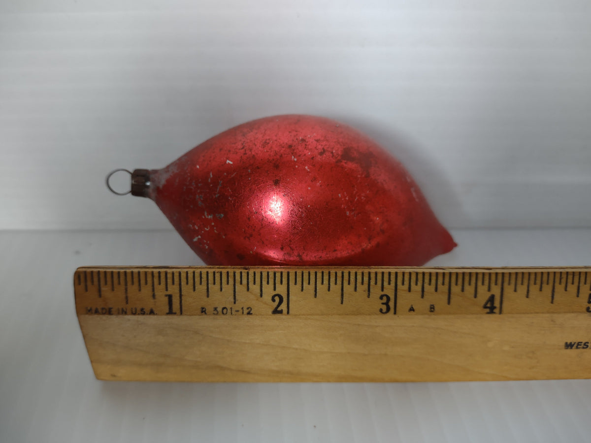 Vintage red teardrop glass ornament next to ruler showing approximately 3 inch length