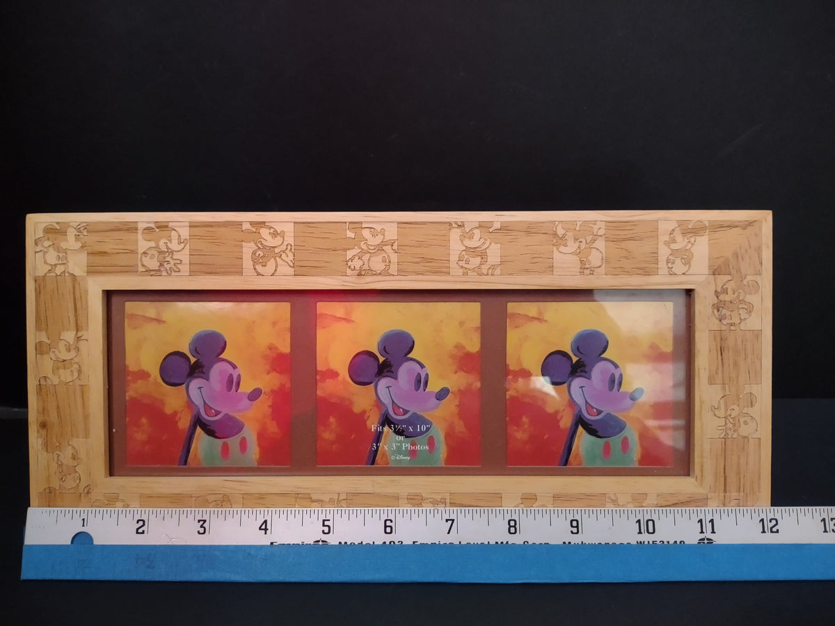 Angled front view of Vintage Disney Mickey Mouse carved wood triple photo frame