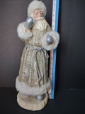 Back view of vintage gold glitter Santa Claus figurine with white faux fur trim and silver rope belt