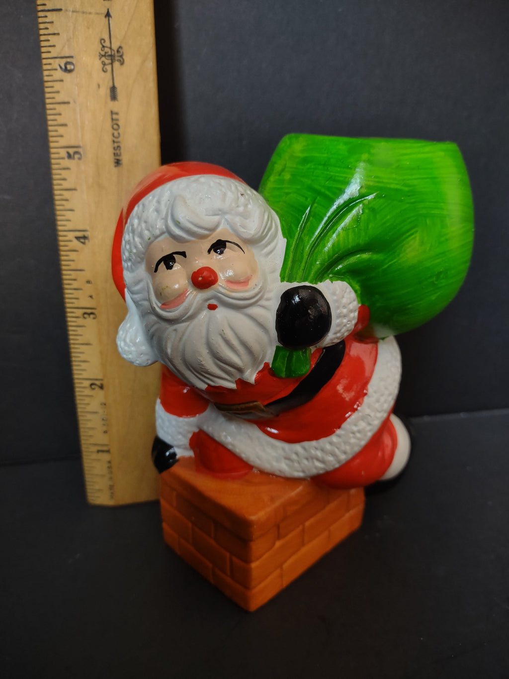 Vintage Merry Lights ceramic Santa Claus chimney candle holder shown with ruler, approximately 5 inches tall