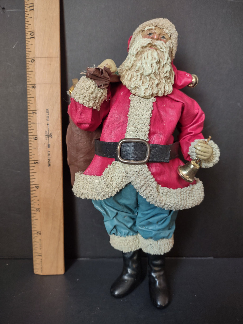 Vintage Possible Dreams Clothetique Santa figurine with teal pants, red jacket, gold jingle bell and burlap sack, approximately 10 inches tall