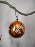 Vintage West German copper amber glass ball ornament with stencil leaf decoration, size reference