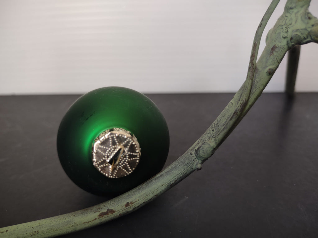 Vintage matte forest green glass ball ornament bottom view showing ornate silver star cap detail