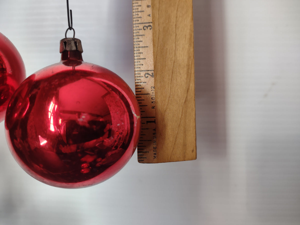 Close-up of Poland-marked silver cap on vintage red glass ball ornament
