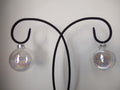 Vintage iridescent clear glass ball ornament with ruler showing approx 2 inch diameter