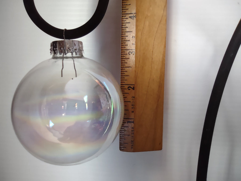 Set of 2 vintage iridescent clear glass ball ornaments hanging on display stand