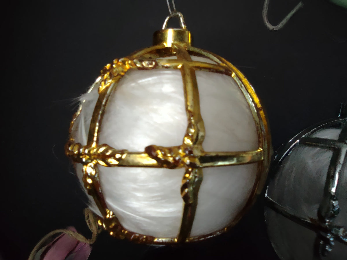 Close-up of Bradford glassspun angel hair ornament with gold plastic cage and decorative molded trim, approx 3 inch diameter