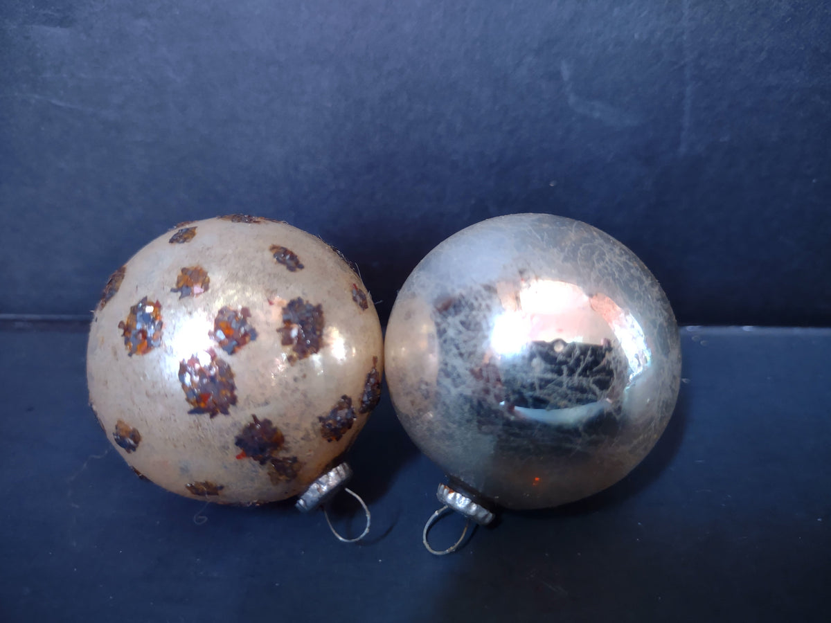 Two vintage Japan mercury glass ball ornaments, gold with dark spot decoration and silver with crackle mica finish