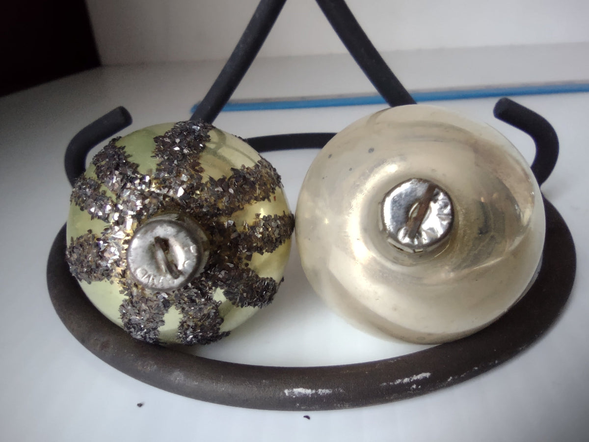 Glitter stripe vintage glass ornament next to ruler showing approx 1.5 inch diameter