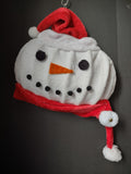Vintage plush snowman face wall hanging with red Santa hat and scarf
