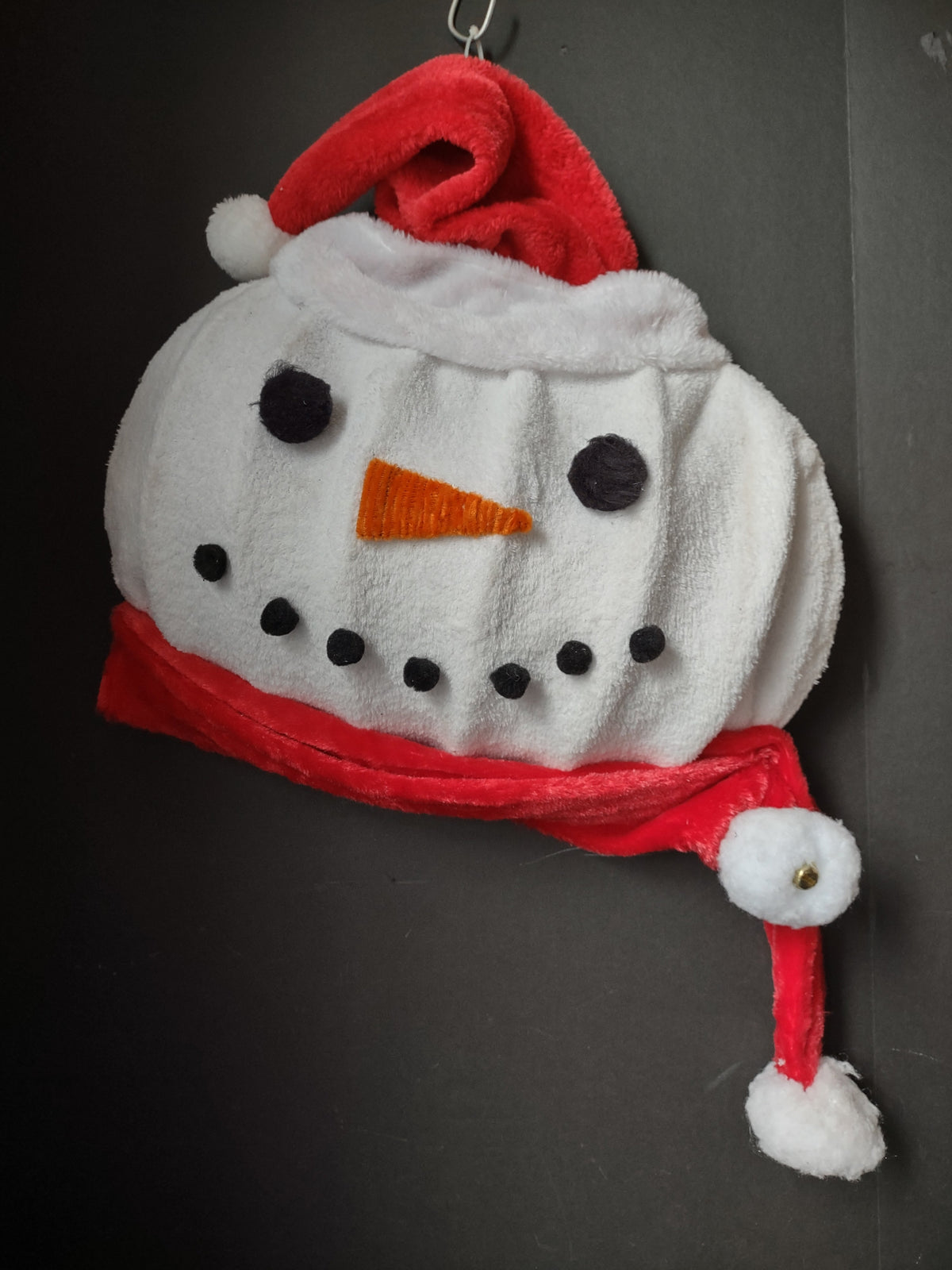 Vintage plush snowman face wall hanging with red Santa hat and scarf