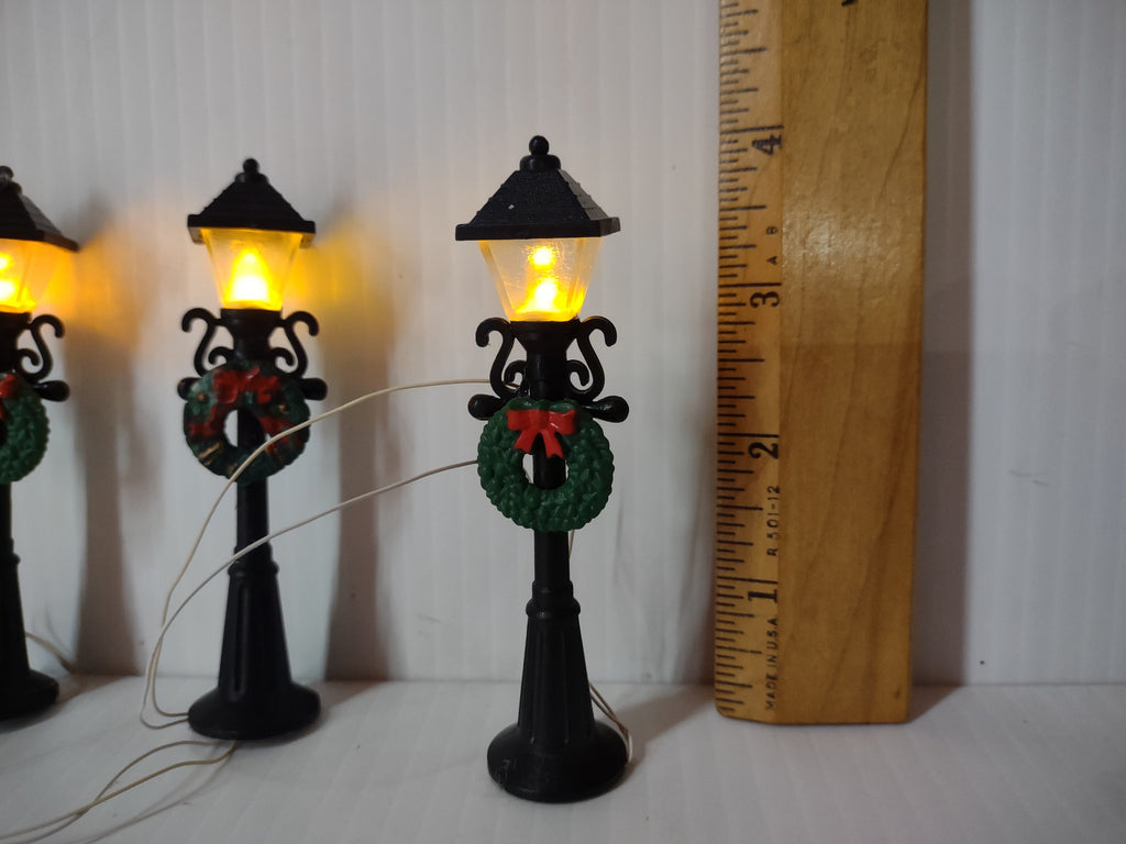 Single lamp post with ruler showing approx 3.5 inch height