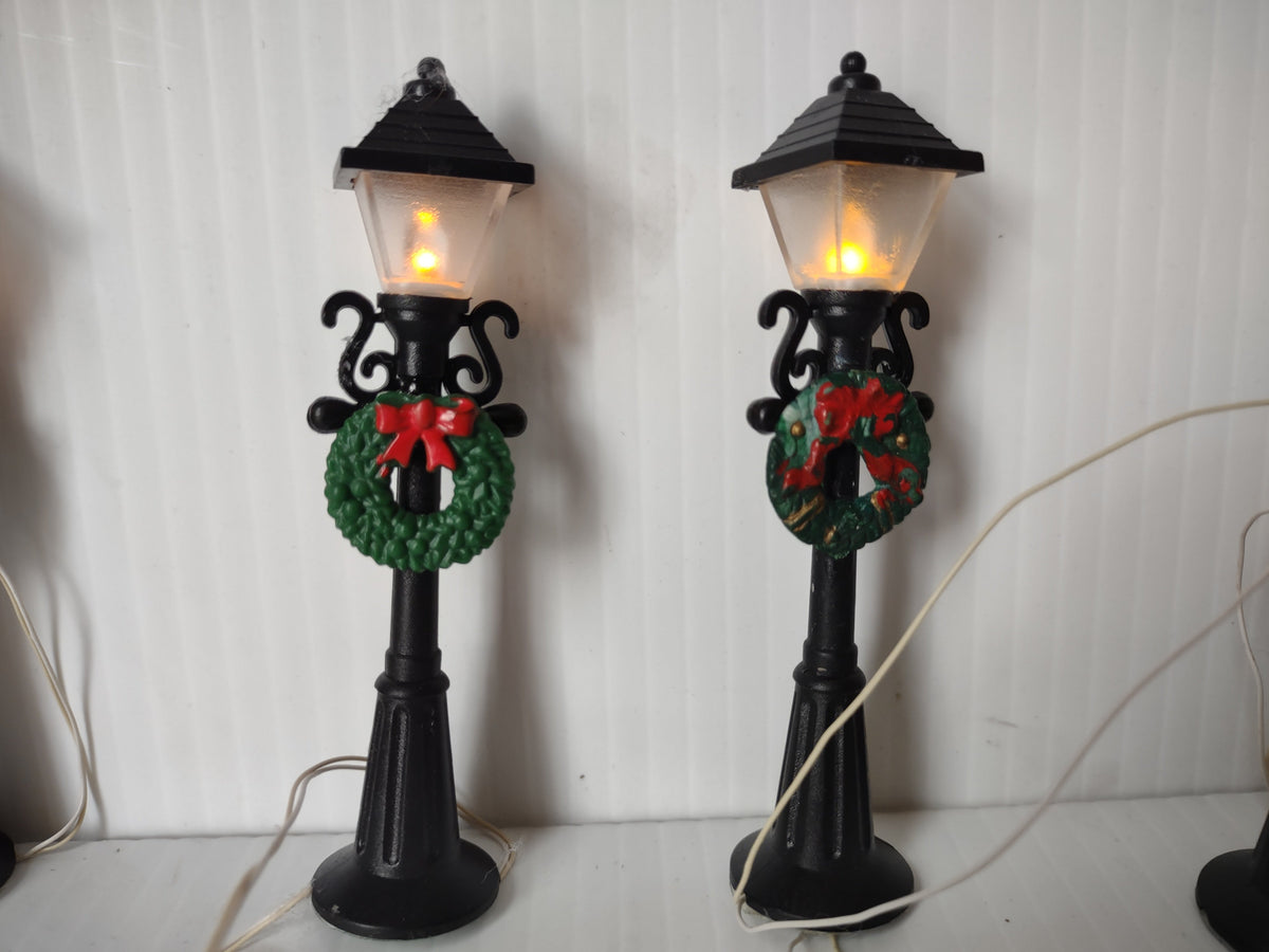 Two lamp posts lit up front view
