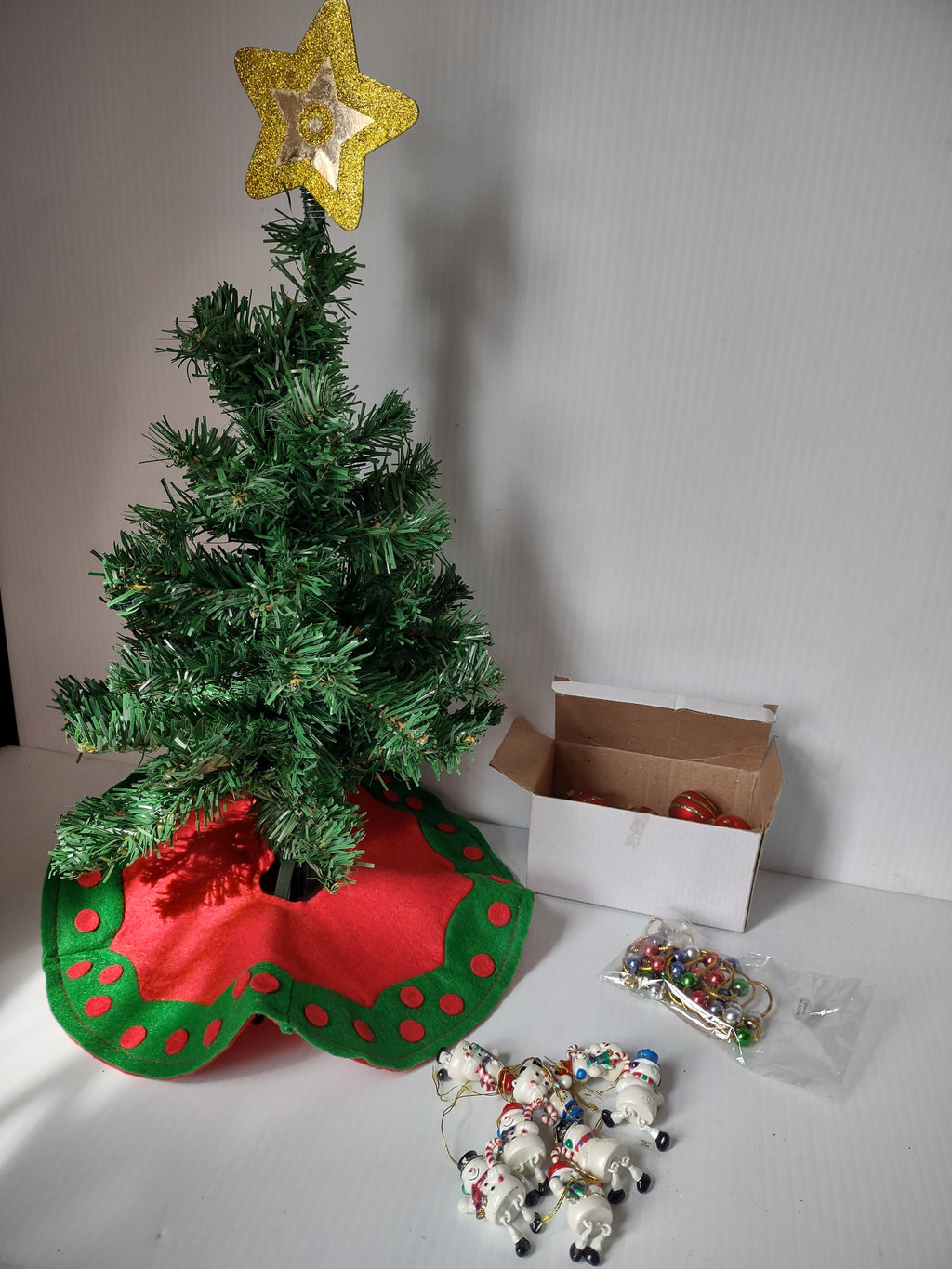 Triangular white box packaging for Holiday Magic Christmas tree set