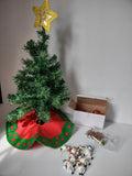 Triangular white box packaging for Holiday Magic Christmas tree set