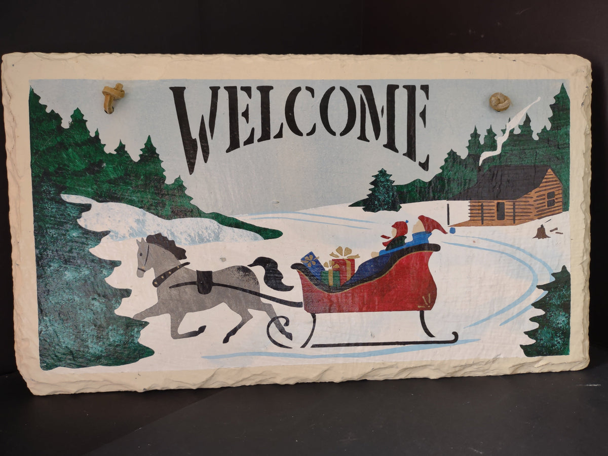 Vintage painted slate welcome sign with horse-drawn sleigh winter scene, front view