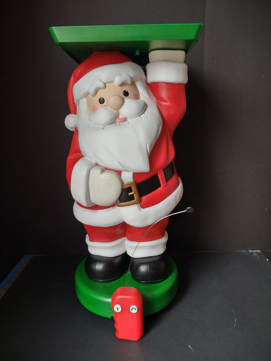 Vintage Santa Claus animated pedestal figurine with green tray top and red battery motor base
