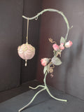 Vintage pink velvet ball ornament with pearl swags and ribbon roses with ruler for scale