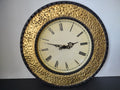 Vintage hammered gold brass round wall clock with Roman numeral dial front view