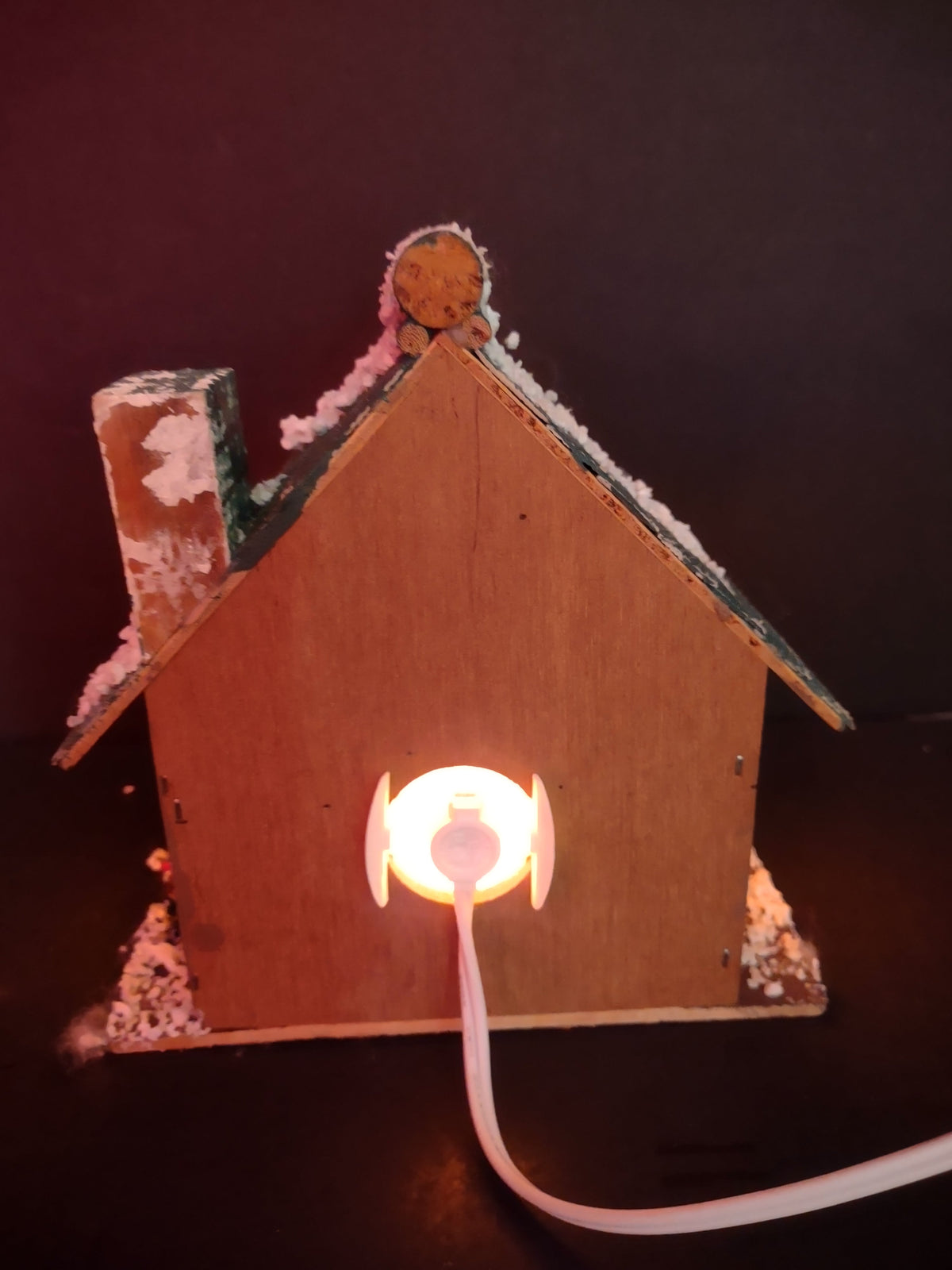 Vintage lighted wood Christmas village house back view showing plug-in cord and light
