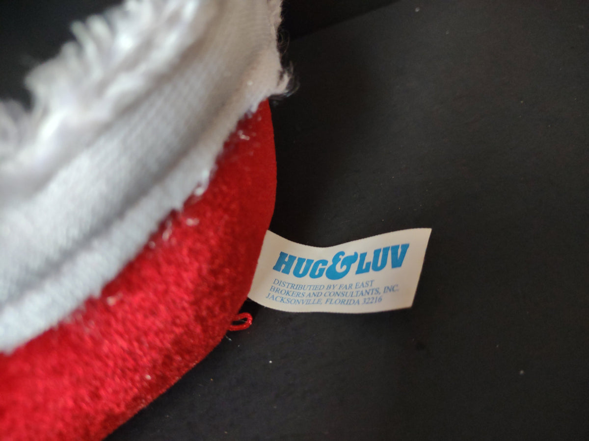 Hug and Luv label tag on vintage singing Santa plush distributed by Far East Brokers Jacksonville Florida