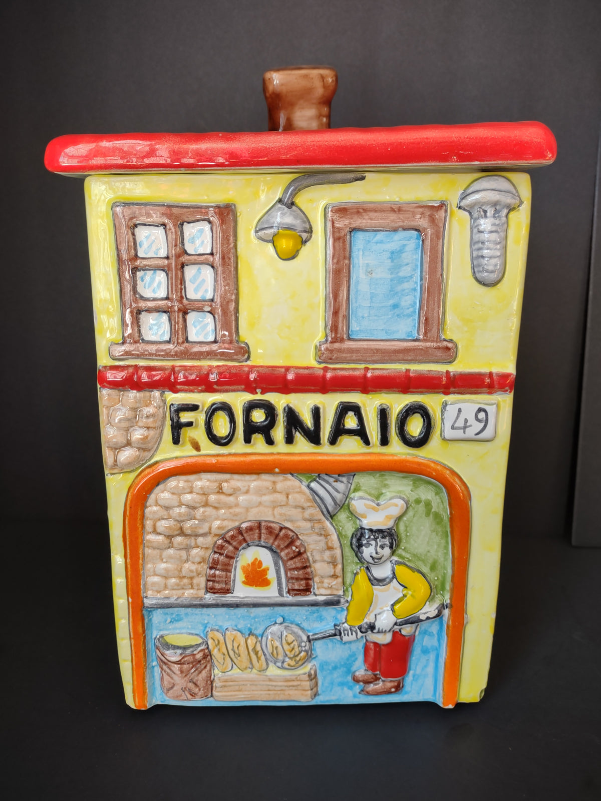 Nino Parrucca yellow ceramic Fornaio bakery cookie jar with red roof and raised baker scene