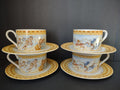 Four Fitz and Floyd Omnibus Americana Cherub cup and saucer sets with blue clouds and yellow geometric borders