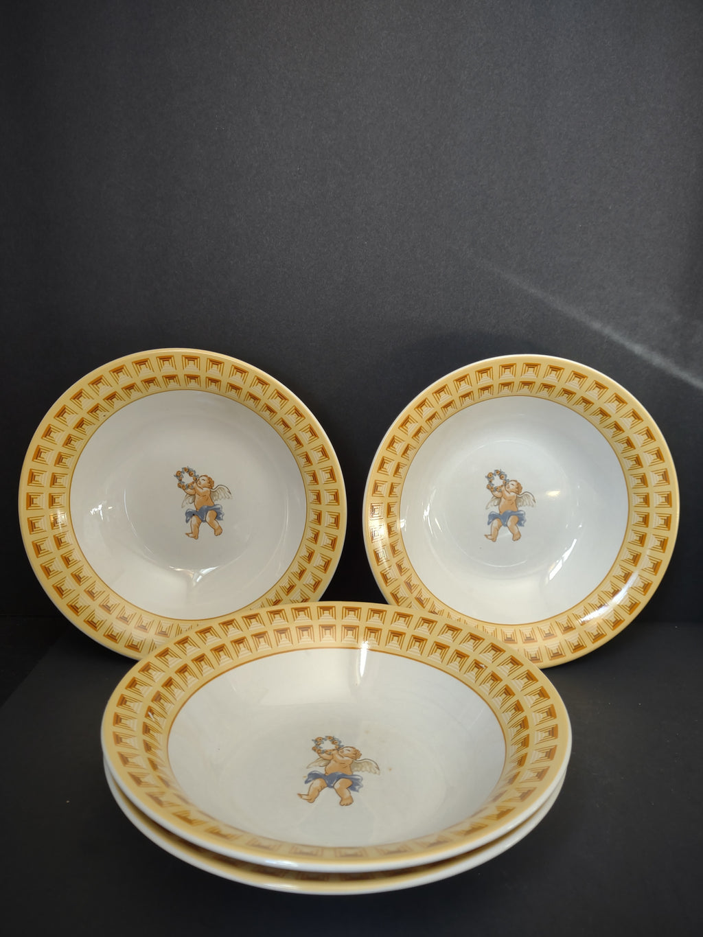 Four white and yellow Fitz and Floyd Omnibus Americana Cherub bowls