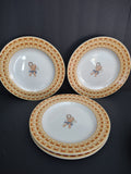 Four Fitz and Floyd Americana Cherub plate pieces with white centers and yellow borders