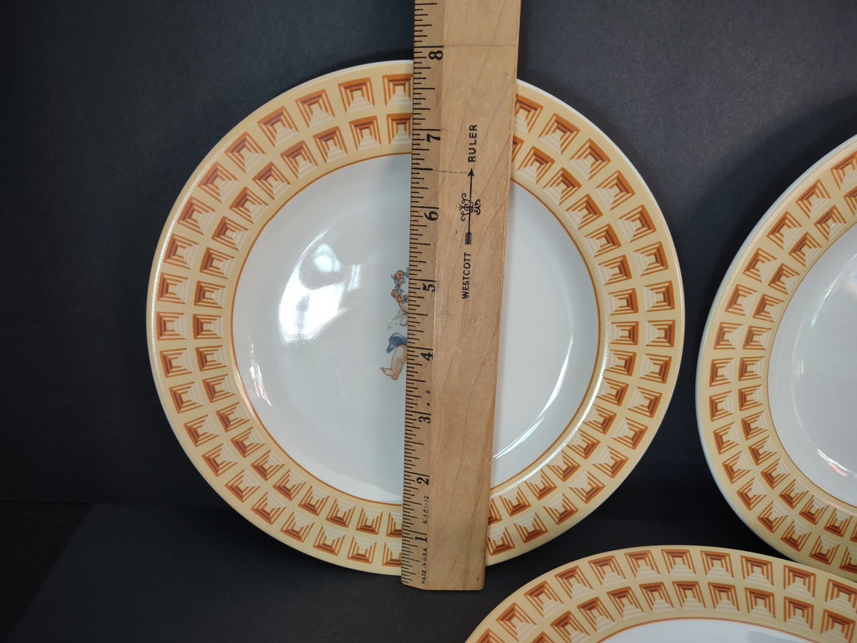 Cherub plate beside ruler showing approximately 8 inch diameter