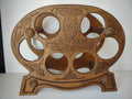 Brown wooden six-bottle wine rack with grape cluster and vine leaf decoration