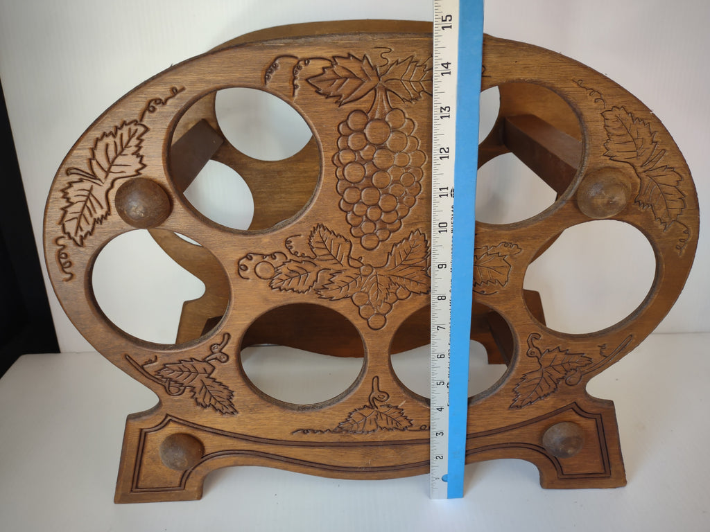 Wooden wine rack beside horizontal ruler showing width and upper edge wear