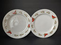 Pair of white Gibson plate pieces decorated with red cardinals and green holly